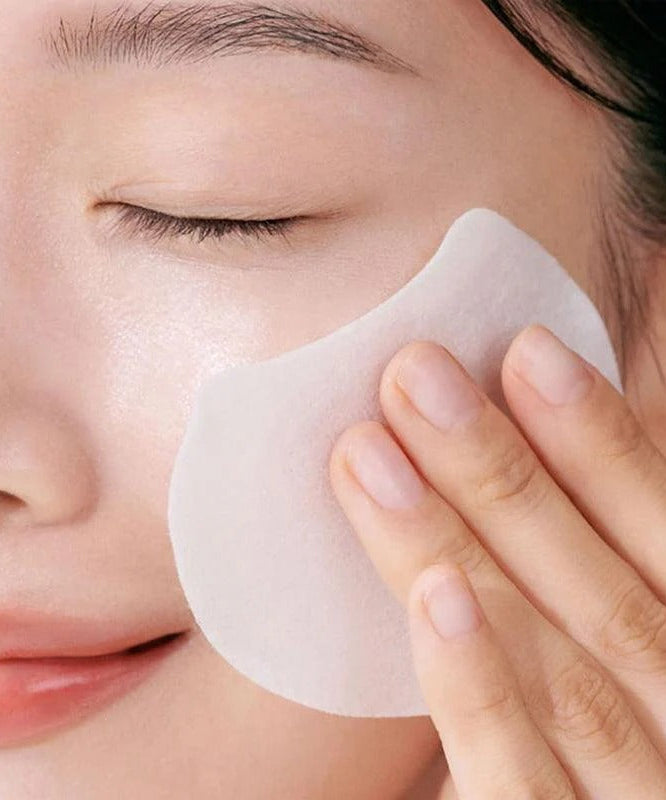 Woman using CELIMAX Pore Dark Spot Brightening Pad 40ea on face for skincare routine