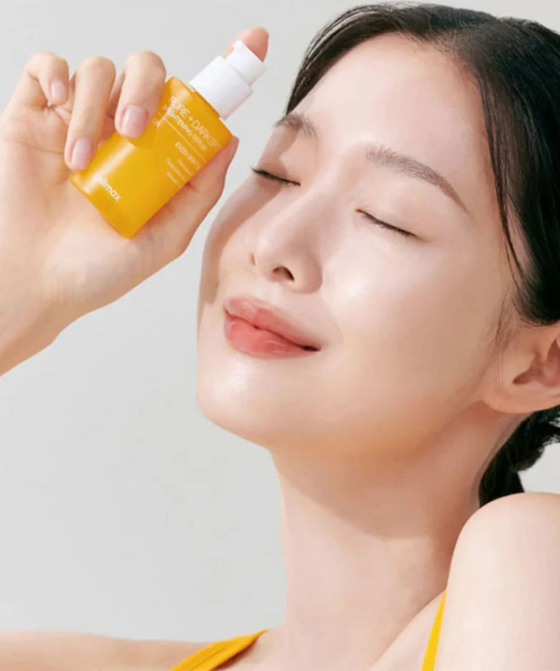 Woman holding CELIMAX Pore Dark Spot brightening Serum 30ml, showcasing glowing skin