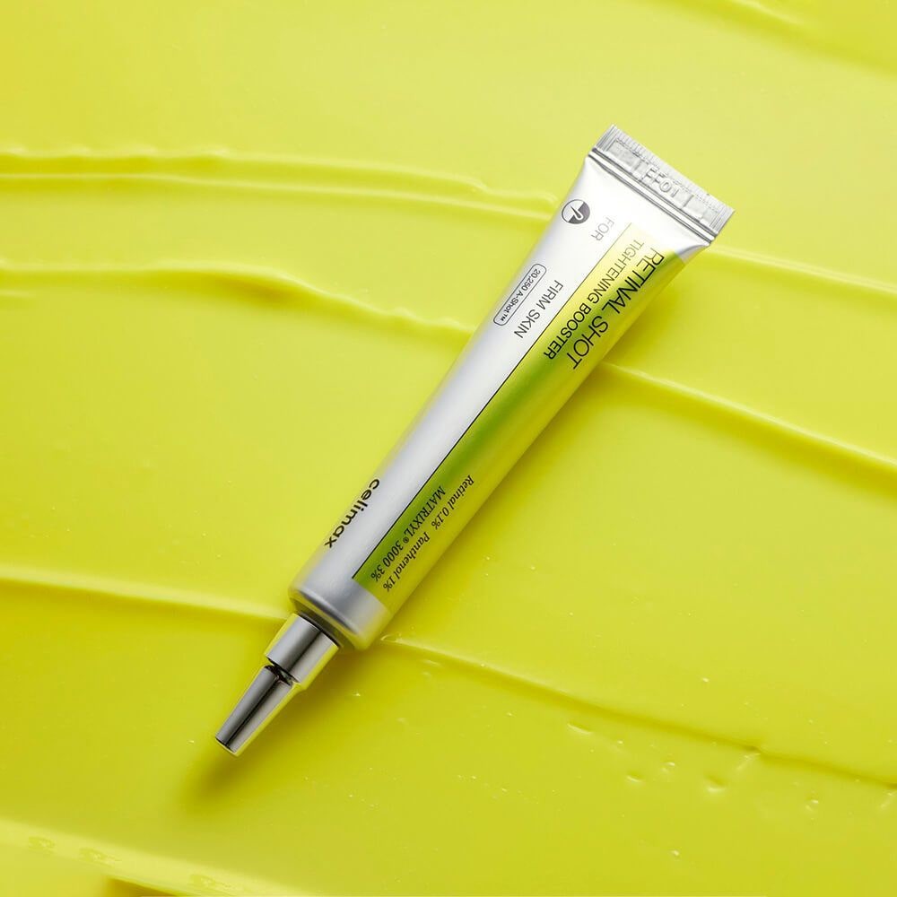 CELIMAX Retinol Shot Tightening Booster 15ml against a textured yellow background