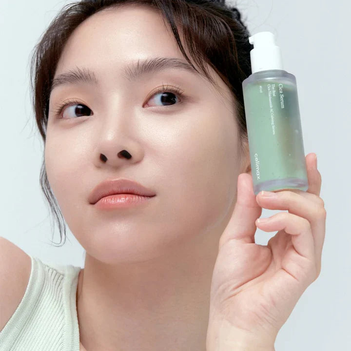 Person holding CELIMAX The Real Cica Nicinamide AC Calming Seru 40ml skincare product.