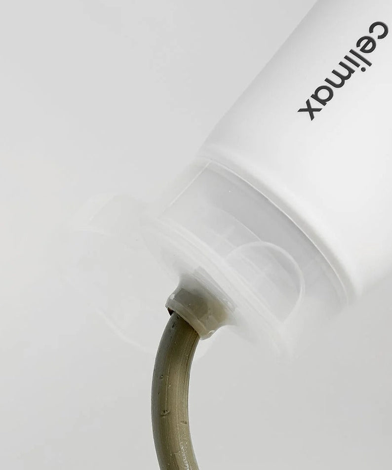 CELIMAX The Real Noni Refresh Clay Mask 120g tube with product being dispensed from the nozzle.
