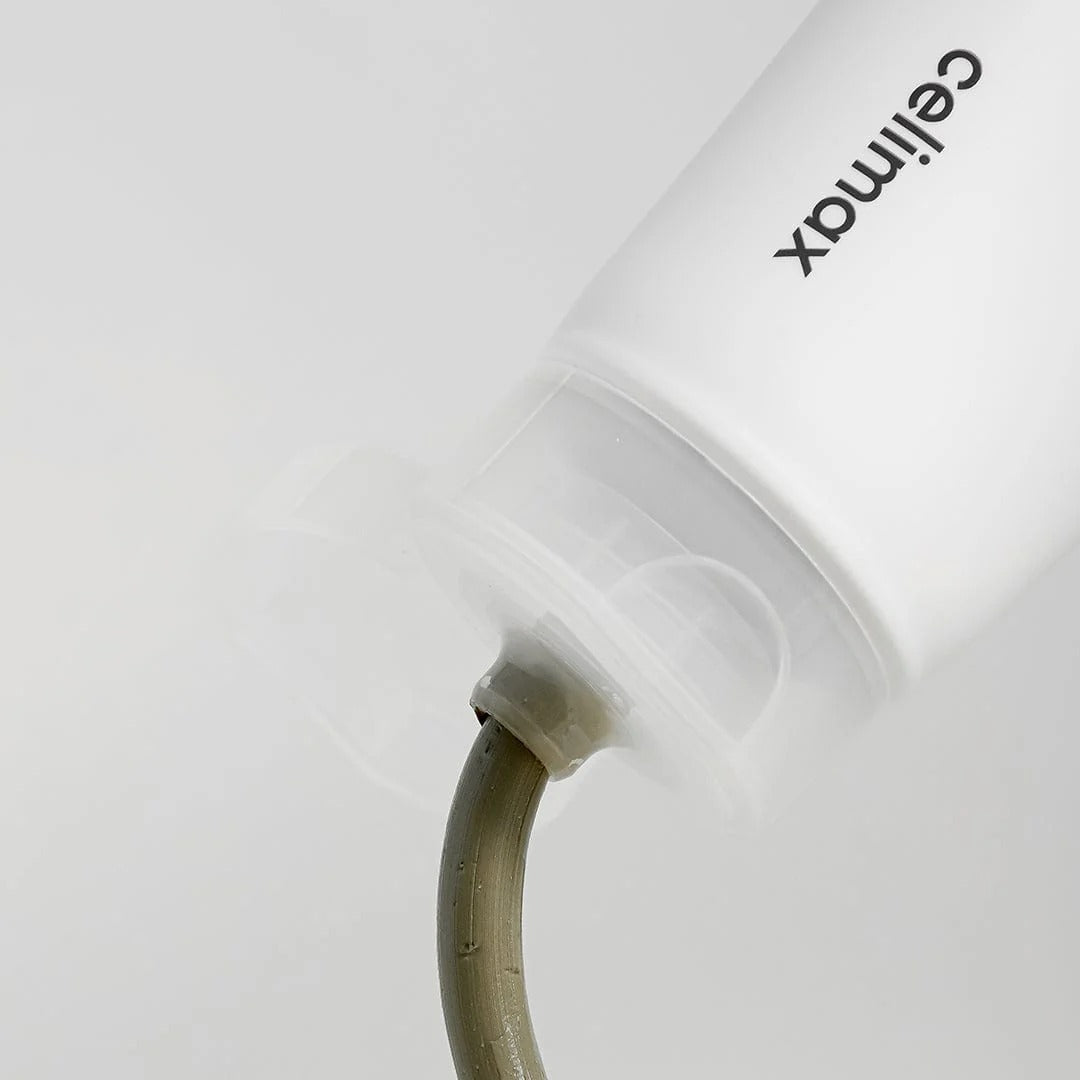 CELIMAX The Real Noni Refresh Clay Mask 120g tube with product being dispensed from the nozzle.
