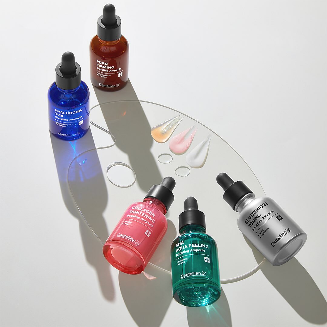 CENTELLIAN 24 Glutathione Toning Boosting Ampoule 30ml 5 Types arranged on a glass surface with colorful dropper bottles
