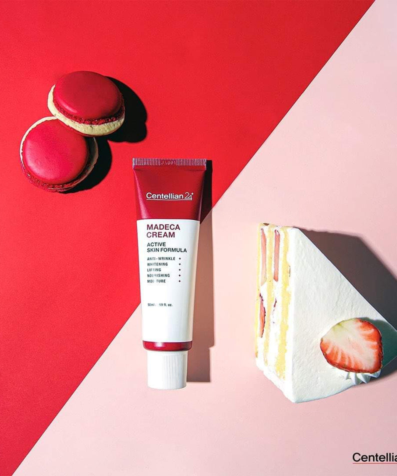 CENTELLIAN 24 Madeca Cream Active Skin Formula 50ml tube on colorful background with dessert.