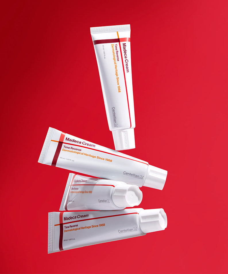 CENTELLIAN 24 Madeca Cream Time Reverse 50ml skincare tubes on red background.