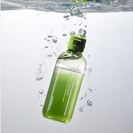 CENTELLIAN 24 Madeca Matcha Cleansing Oil 200ml bottle submerged in water, highlighting product's hydrating properties and unique design.