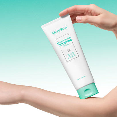 CENTELLIAN 24 Relaxing Up Body Boosting Cream 250ml in a hand, showcasing the product tube against a gradient background.