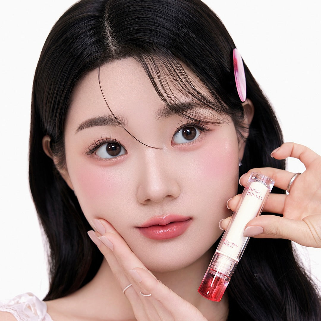 Woman holding CLIO Crystal Glam Tint with a youthful glow.