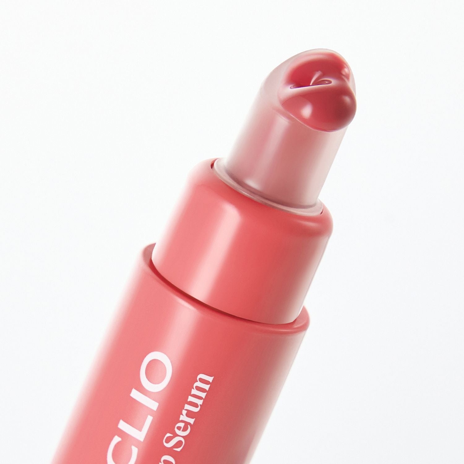 Close-up of the pink CLIO Glaze Lip Serum tube with heart-shaped applicator.