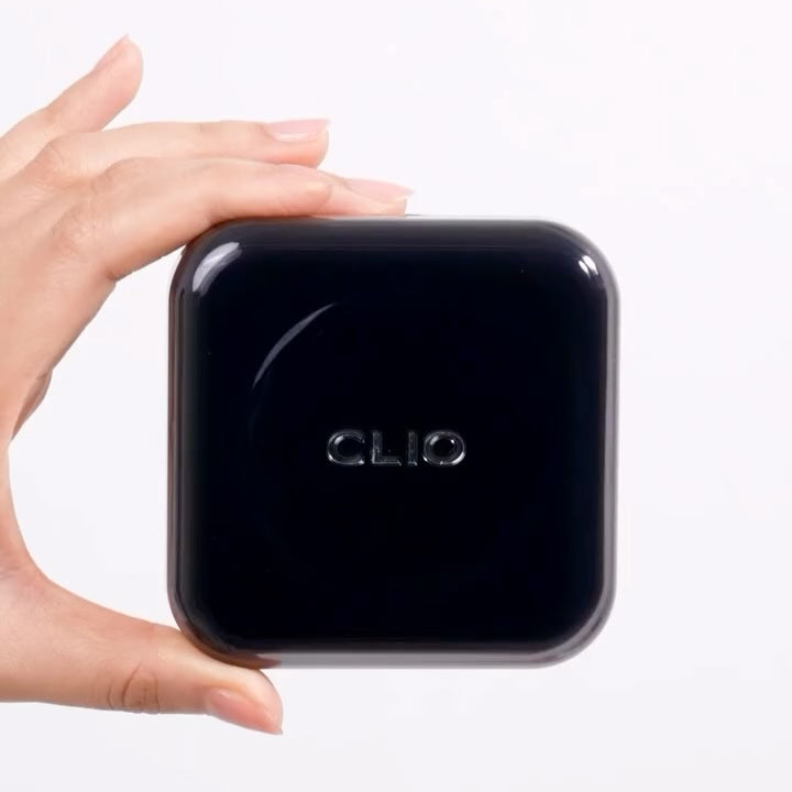 Hand holding CLIO Kill Cover Founwear Cushion Set (Products+Refill) with black packaging.