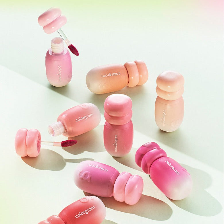 Assorted COLORGRAM Juicy Jam Blur Tint 5g bottles displayed on a pastel background