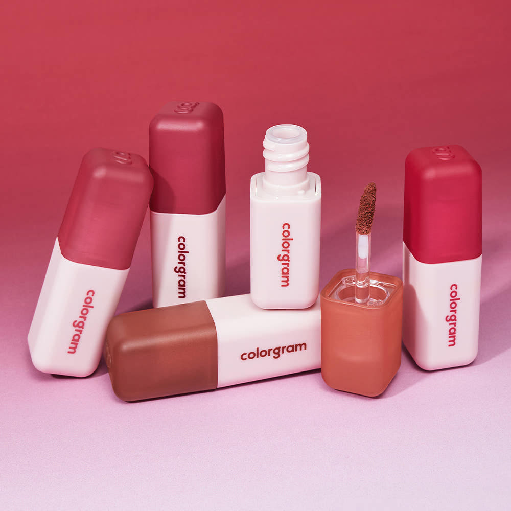 COLORGRAM Nude Blur Tint lip products on a pink gradient background, showcasing various shades and textures.