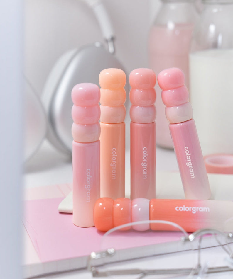 COLORGRAM Tanghulu Tangle Tint Milk 3g lip tints displayed on a vanity table with makeup essentials in soft pastel shades.