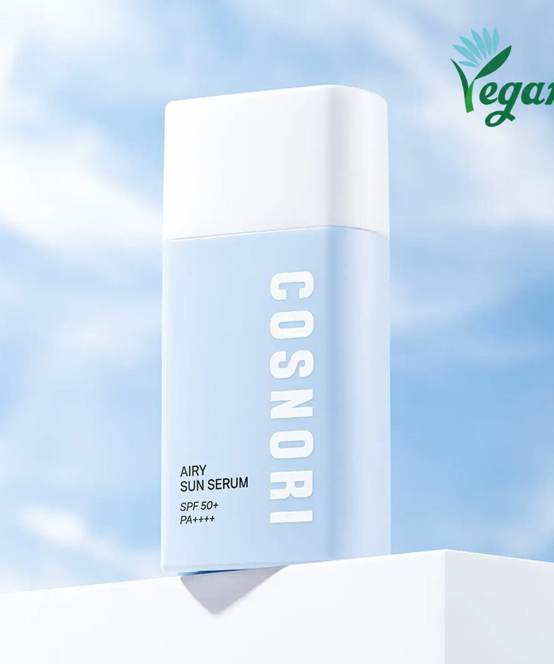 COSNORI Airy Tone Up Sun Serum with SPF 50+ PA++++, vegan-friendly skincare against a blue sky background.