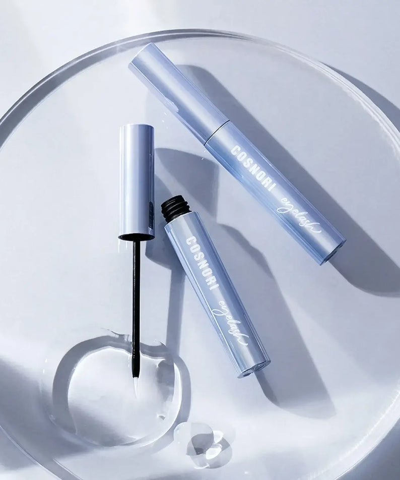 COSNORI Intensive Eyelash Serum on a clear tray with applicator brush.