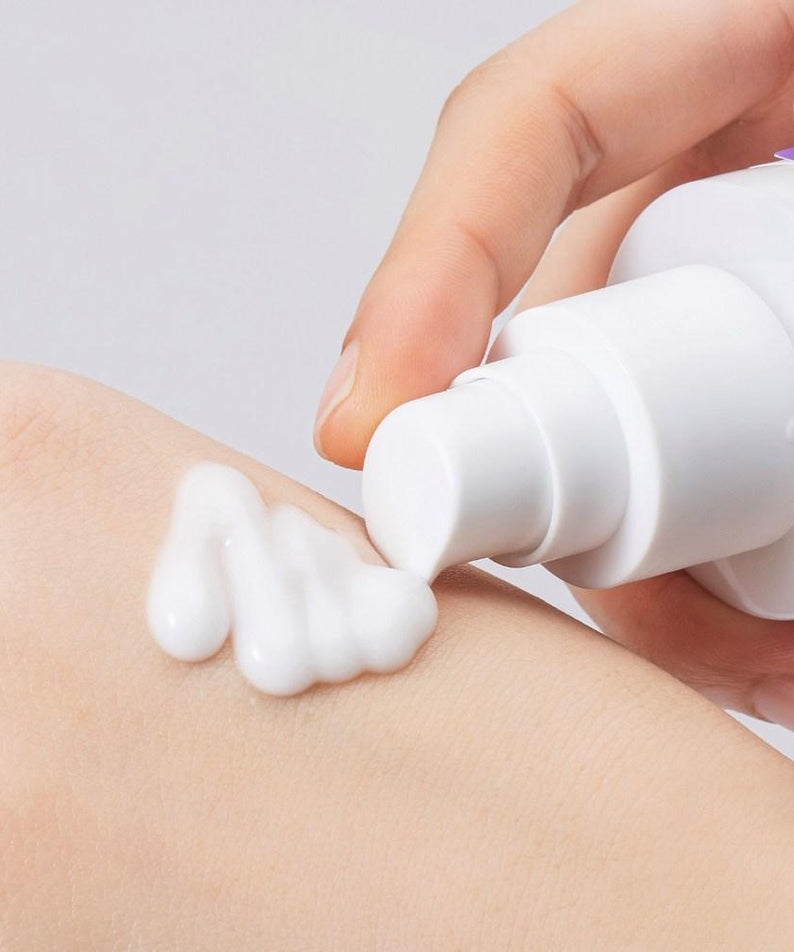 Applying COSNORI Panthenol Barrier Emulsion 150ml on skin for hydration.