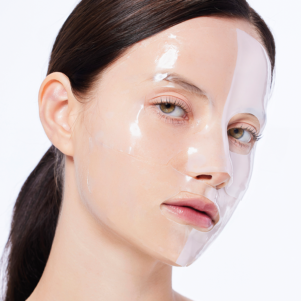 Woman wearing COSRX Advanced Snail Mucin Glass Glow Hydrogel Mask (3 mask) for skincare