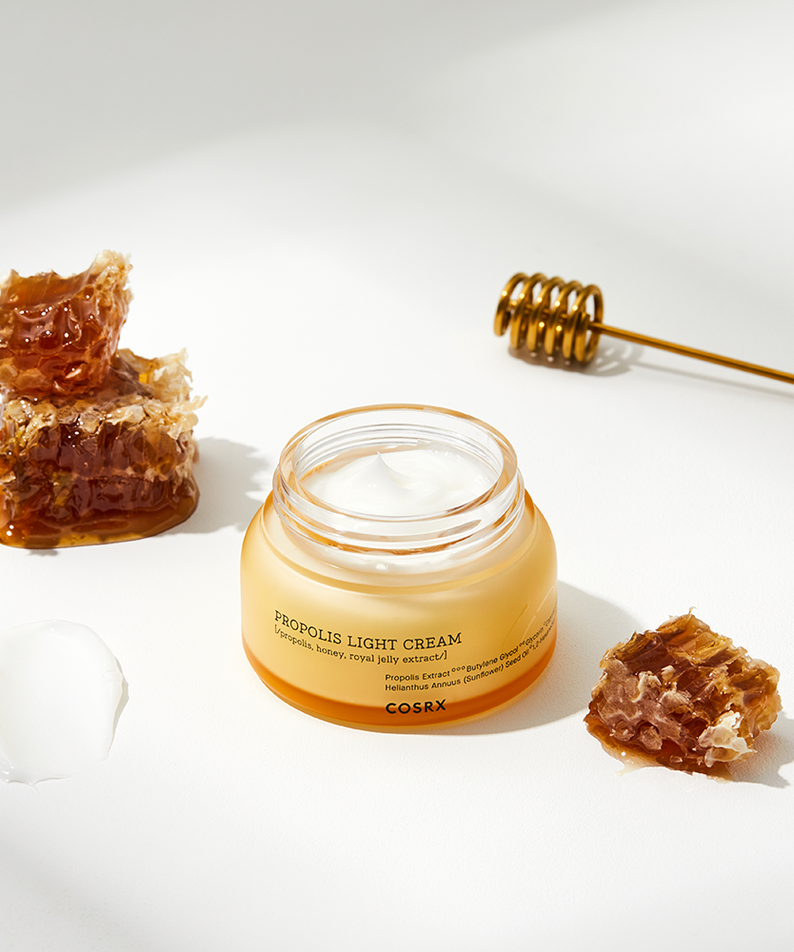COSRX Full Fit Propolis Light Cream 65ml on a white background with honeycomb and a honey dipper.