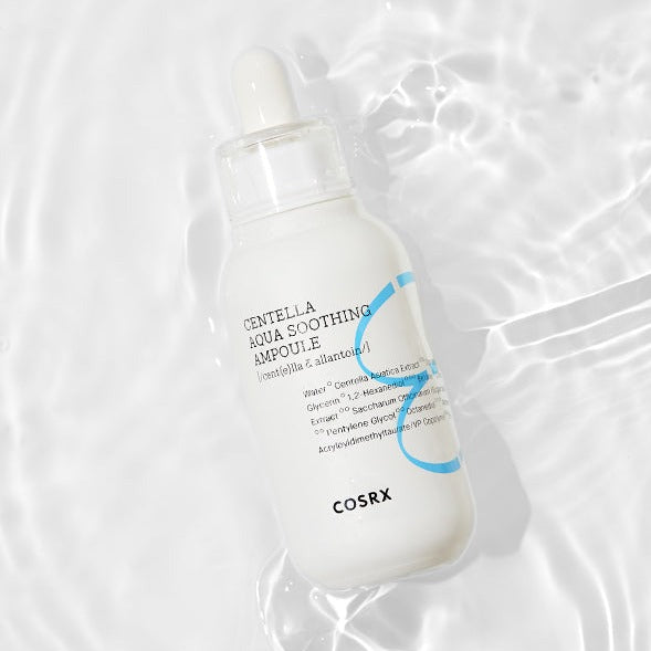Bottle of COSRX Hydrium Centella Aqua Soothing Ampoule 40ml on a watery surface