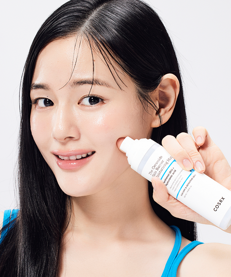 Young woman applying COSRX The Ceramide Skin Barrier Moisturizing Mist 120ml to her face for hydration and skin barrier support.