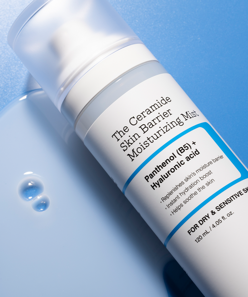 Bottle of COSRX The Ceramide Skin Barrier Moisturizing Mist 120ml on a blue background with product details visible.