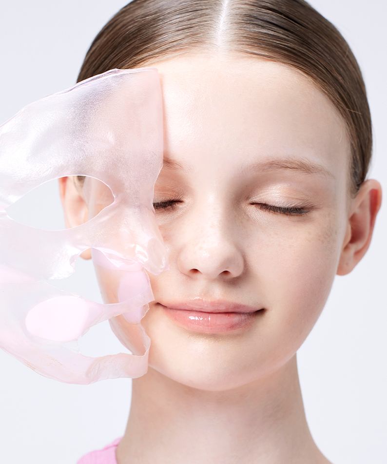 Woman applying COSRX The Peptide Collagen Lifting Glow Hydrogel Mask (3 sheets) to her face for skincare