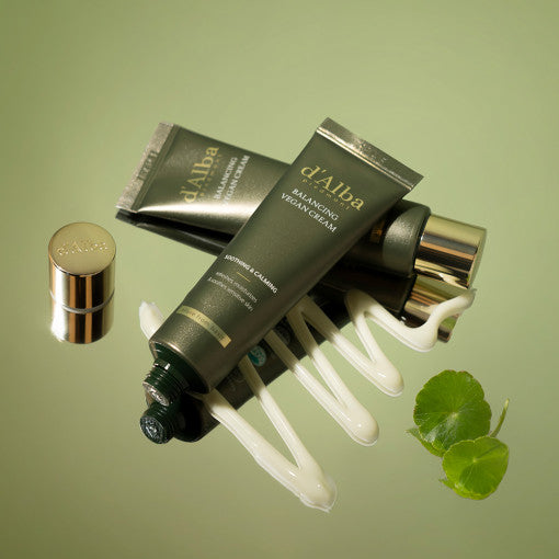 D'ALBA Mild Skin Balancing Vegan Cream 55ml tubes on a green background with cream texture and plant leaves.