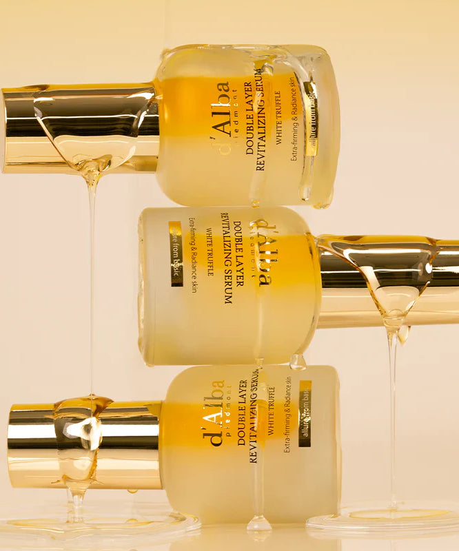 Three bottles of D'ALBA Vegan Double Serum 30ml stacked with honey drizzling down, highlighting its luxurious and nourishing formula.