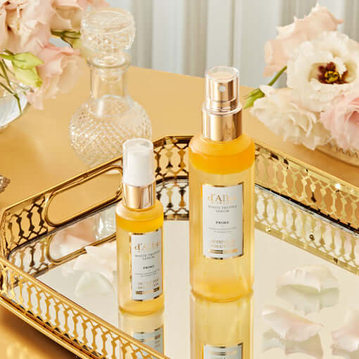 D'ALBA Vegan Prime Intensive Serum 100ml bottles on a gold tray with flowers
