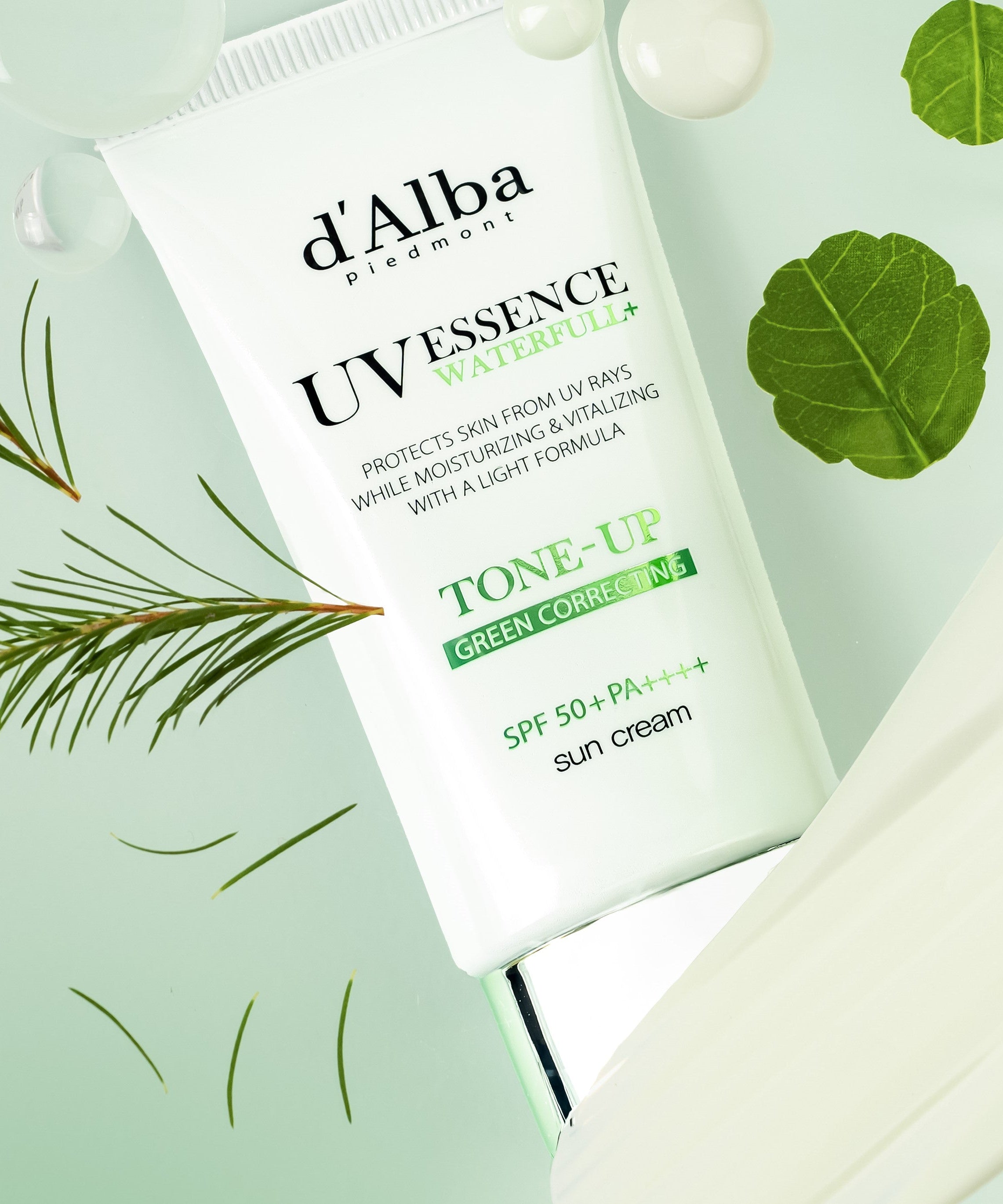D'ALBA Vegan Waterfull Green Tone-Up Suncream 50ml packaging displayed with green leaves and droplets.