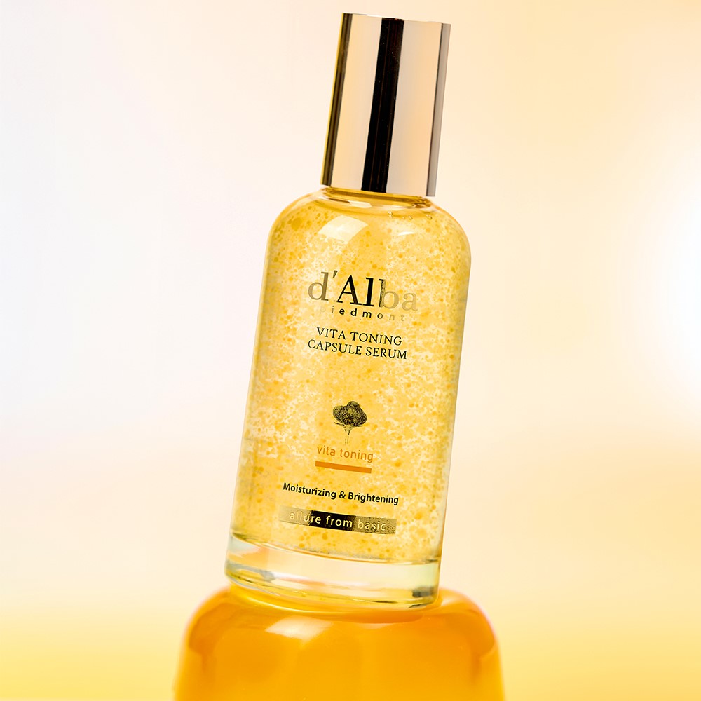 D'ALBA Vita Toning Capsule Serum bottle against a yellow background