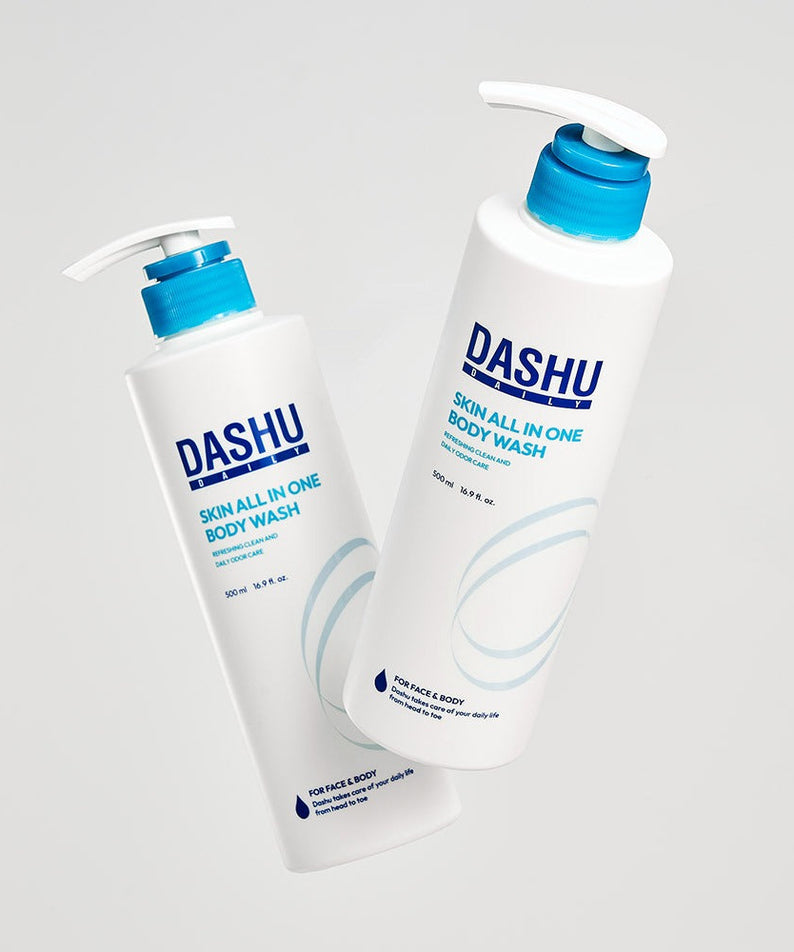 Two bottles of DASHU Daily Skin All-in-One Body Wash 500ml with blue caps standing against a light background.