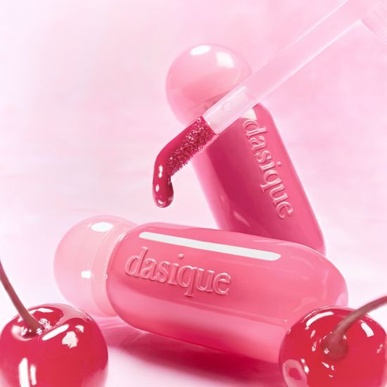 DASIQE Dewy Glow Tint with cherry-inspired pink hue, showcasing sleek tube design and applicator for radiant makeup.