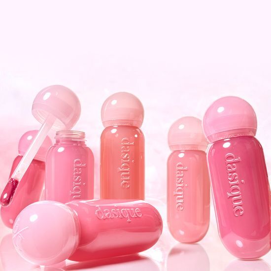 Various shades of DASIQE Dewy Glow Tint in pink bottles, highlighting the product's moisturizing and glowing properties.