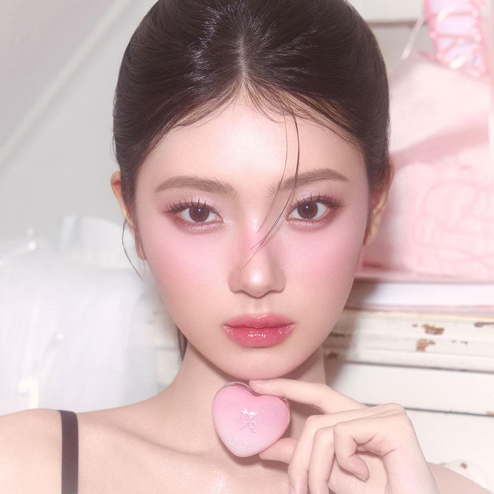 Person holding a pink DASIQUE Daisy Candy Rolling Pot showcasing the product's unique design and color in a close-up view.