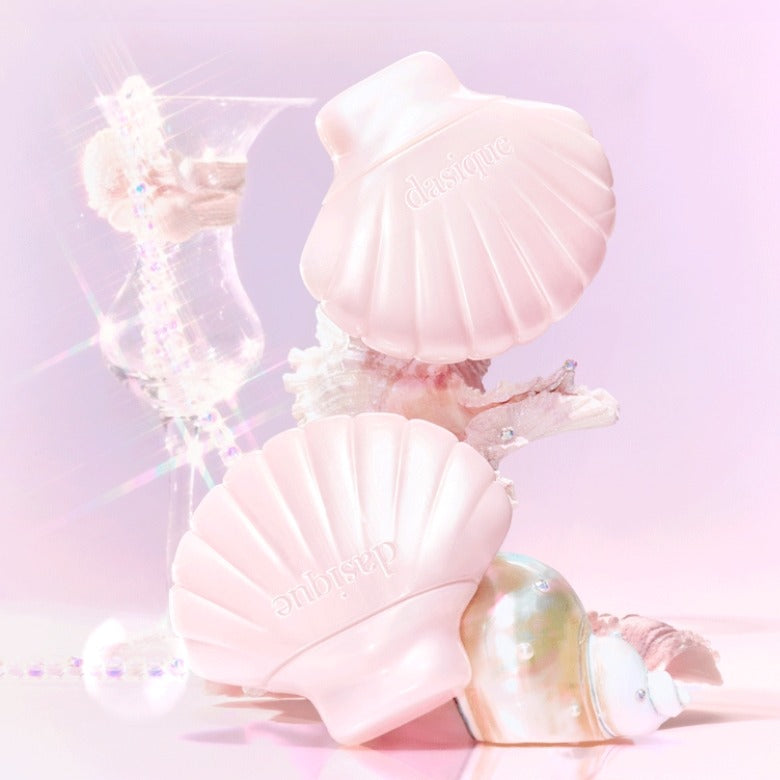 DASIQUE Glow Shell Base product packaging featuring seashell-shaped design on a pink background.