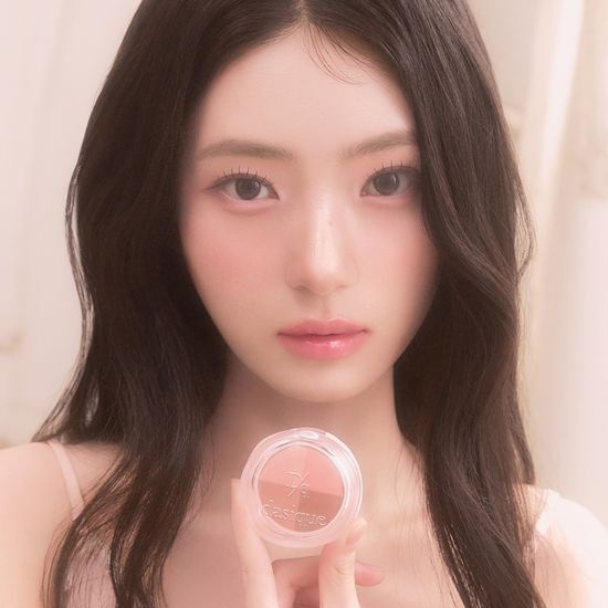 Woman holding DASIQUE Multi Quad Shadow, showcasing makeup product