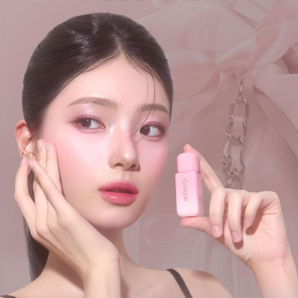 Model holding pink DASIQUE Silky Veil Blush against soft pink background