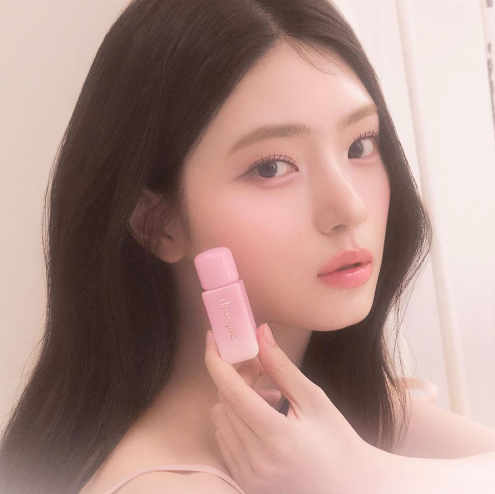Model holding DASIQUE Silky Veil Blush with a soft-focus effect, highlighting the product's smooth, silky finish on skin.