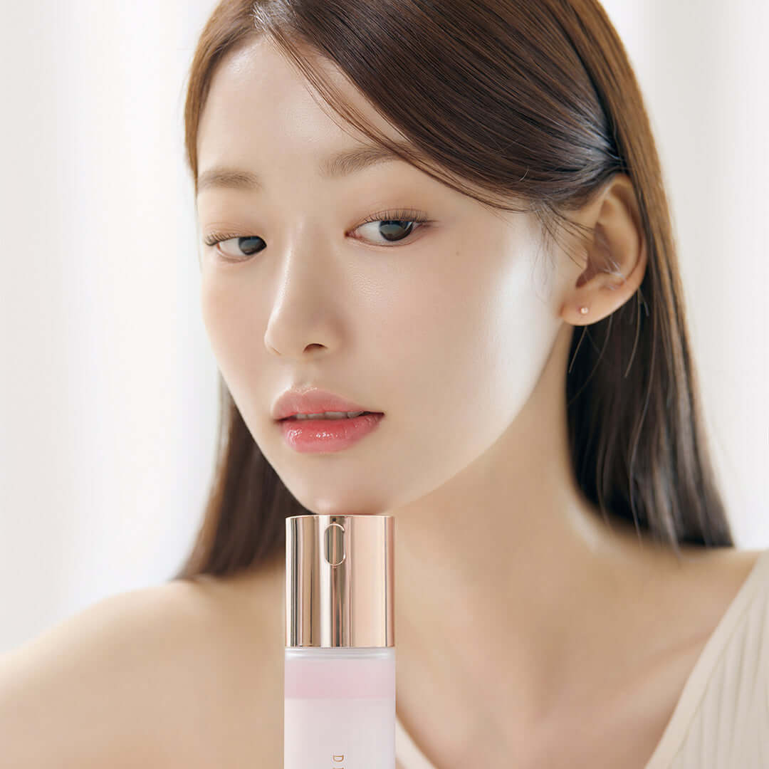 Woman holding DEAR DAHLIA Endless Skin Cream Mist bottle