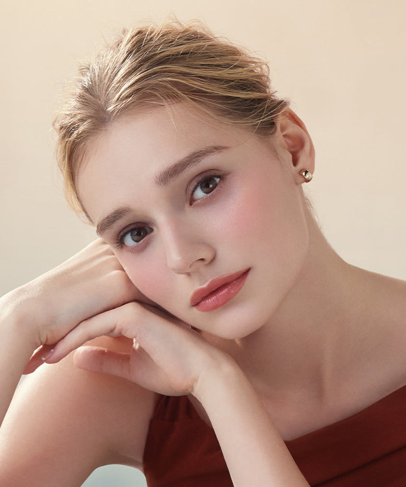 Model wearing DEAR DAHLIA Lip Paradise Sheer Dew Lipstick with soft makeup look