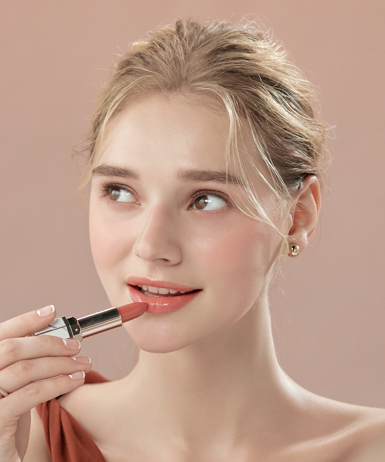 Woman applying DEAR DAHLIA Lip Paradise Sheer Dew Lipstick in pink shade