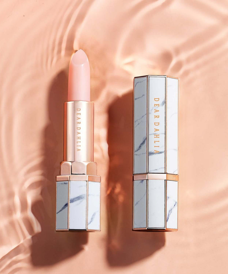 DEAR DAHLIA Paradise Blooming Night lipstick elegantly displayed on a peach background with water ripple effect.