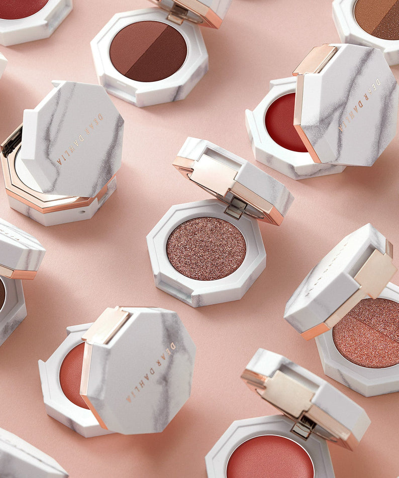 DEAR DAHLIA Paradise Dual Palette displayed with open and closed makeup compact cases on a soft pink surface.
