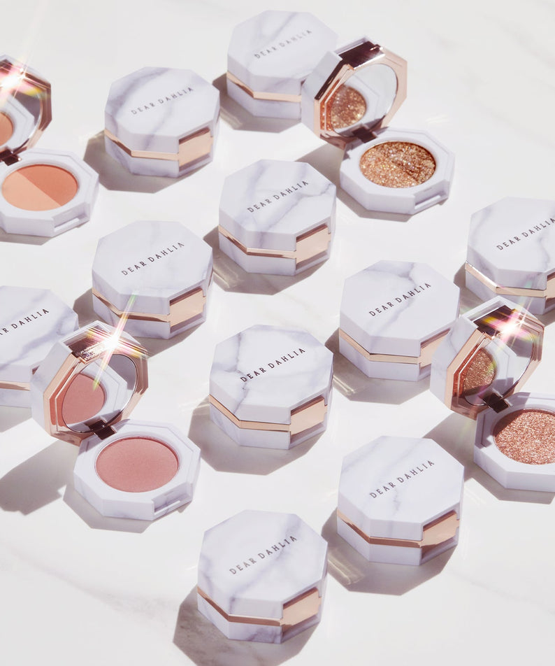 DEAR DAHLIA Paradise Dual Palette with various makeup shades in elegant marble packaging.