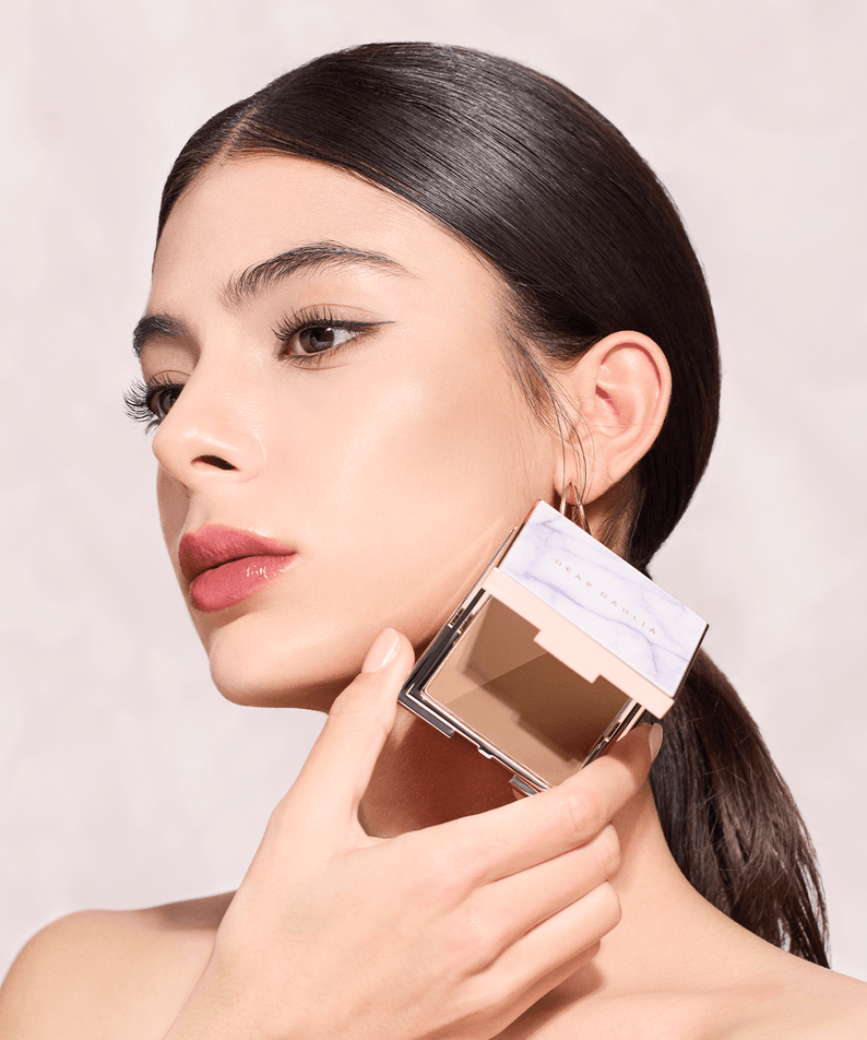 Model applying DEAR DAHLIA Skin Silhouette Contour Dou for a flawless finish