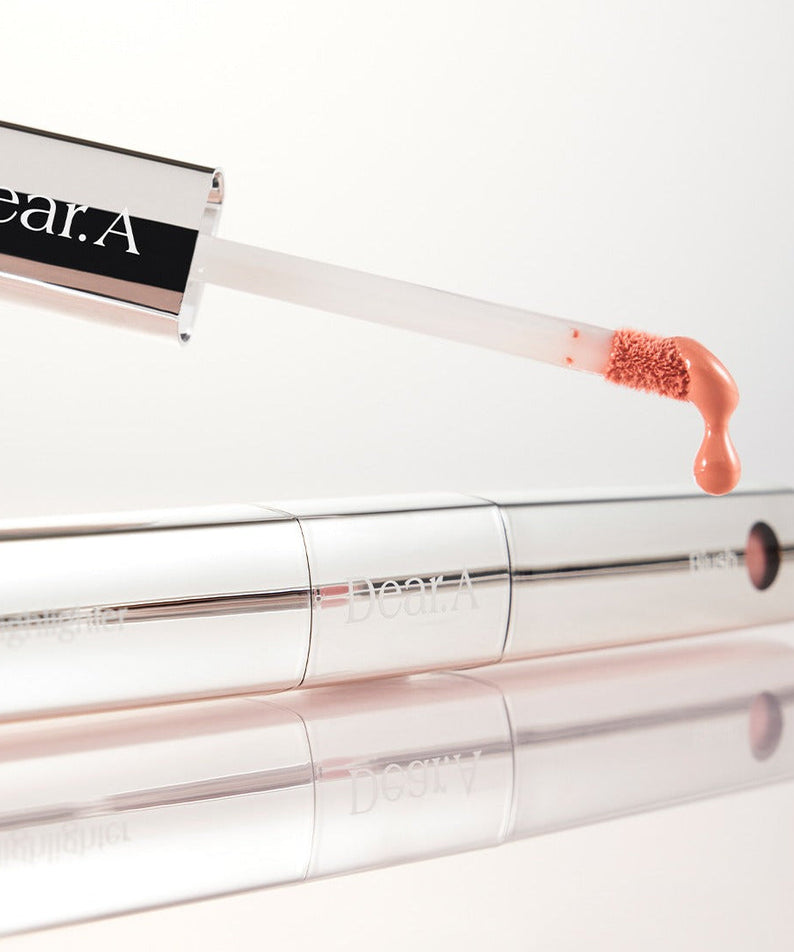 DEAR.A Blush & Beam Dual Stick beauty product in silver packaging with applicator, highlighting makeup innovation and elegance.