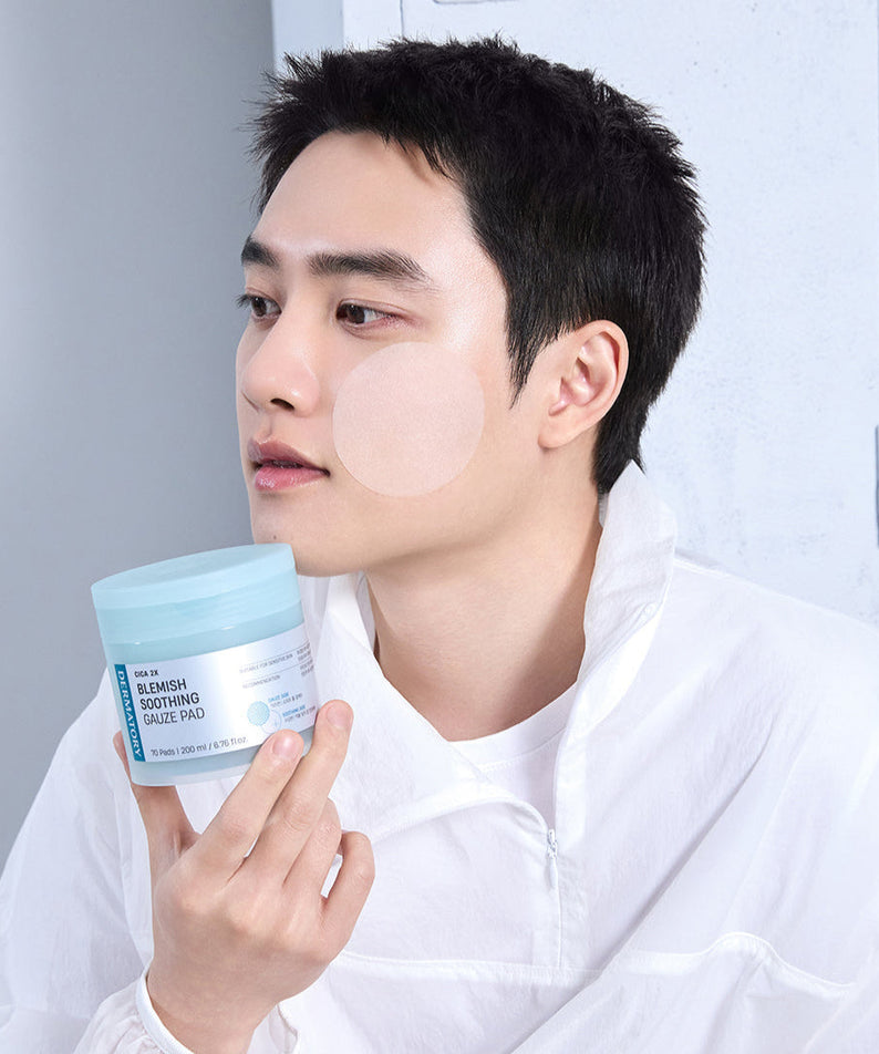 Man using DERMATORY Cica Exosome Blemish Soothing Gauze Pad 70 Pads on face in skincare routine.