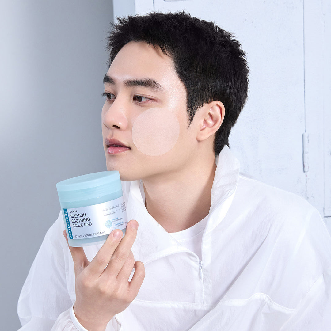 Man using DERMATORY Cica Exosome Blemish Soothing Gauze Pad 70 Pads on face in skincare routine.