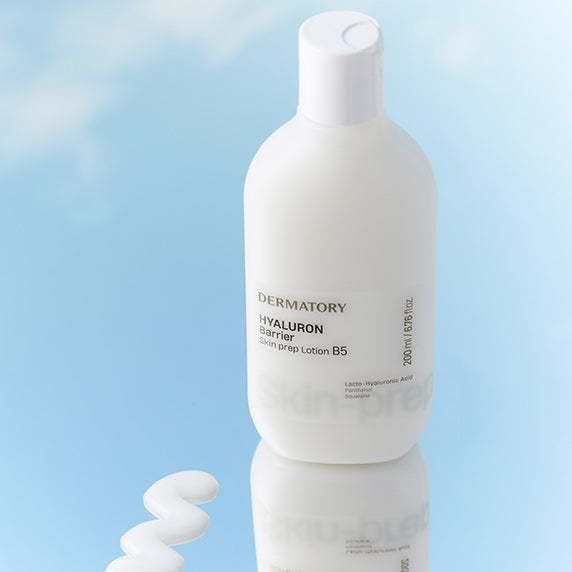 DERMATORY Hyaluronic Barrier Skin Prep Lotion B5 200ml on a reflective surface with a spiral of lotion to the side.